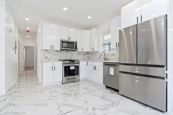 a kitchen with stainless steel appliances granite countertop a refrigerator sink and cabinets
