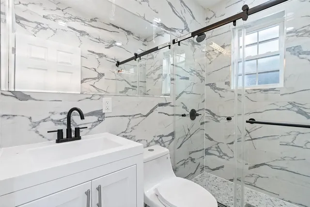 a bathroom with a sink toilet and shower