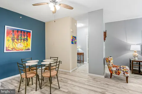 a kitchen with stainless steel appliances kitchen island granite countertop a table chairs microwave and sink