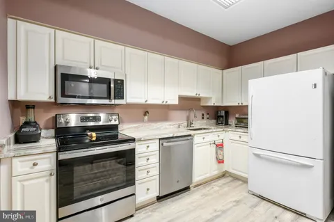 a kitchen with a sink a stove and refrigerator