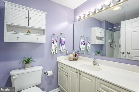 a bedroom with a bed and a lamp