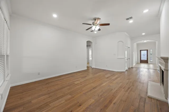 wooden floor in an empty room with a window