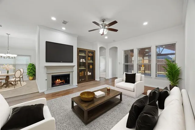 a living room with furniture a flat screen tv and a fireplace