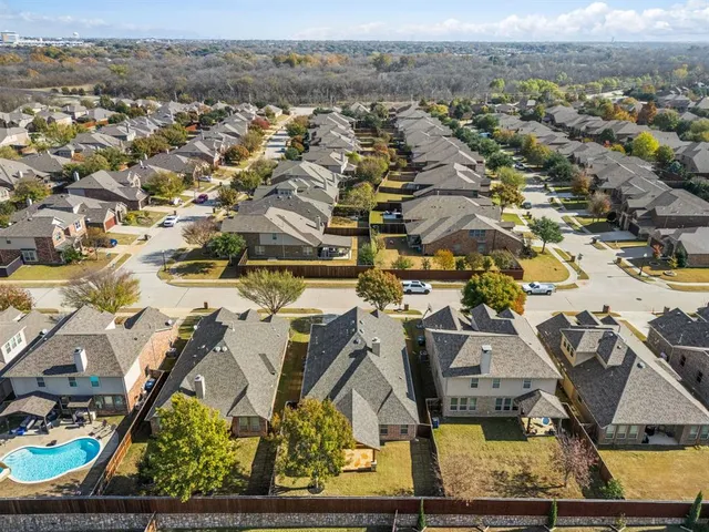 an aerial view of residential houses with outdoor space