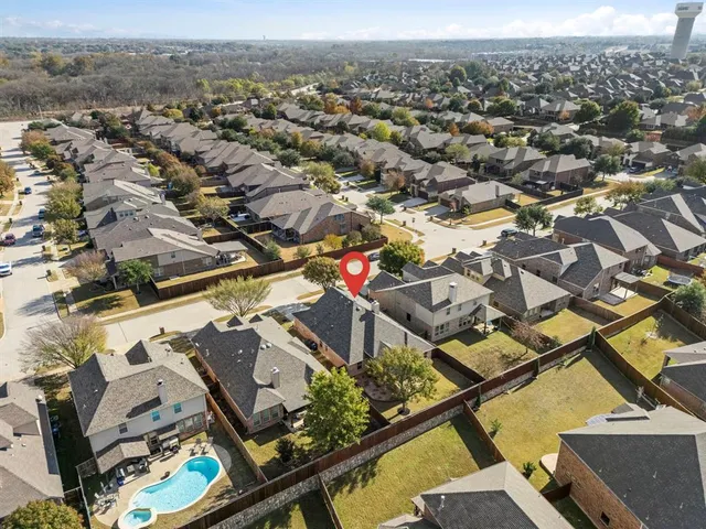 an aerial view of a residential houses with outdoor space