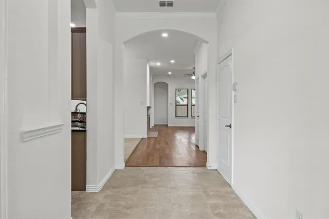a view of a hallway with wooden floor and staircase
