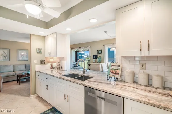 a kitchen with sink and cabinets