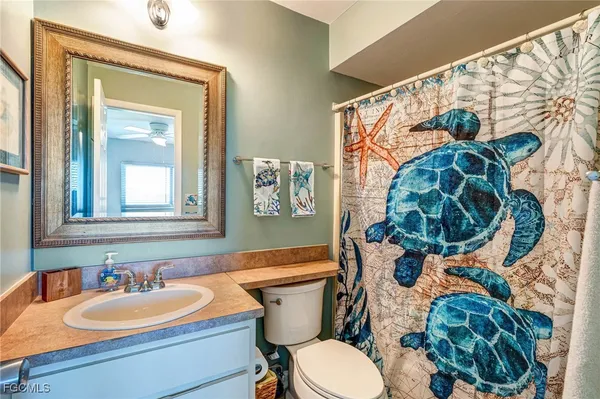 a bathroom with a sink mirror vanity and toilet