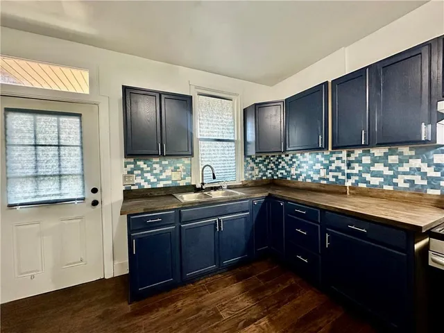 a kitchen with granite countertop wooden cabinets and granite counter tops