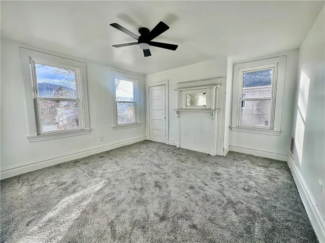 a view of a livingroom with a dishwasher cabinets and a window