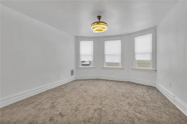 an empty room with a ceiling fan and a ceiling fan