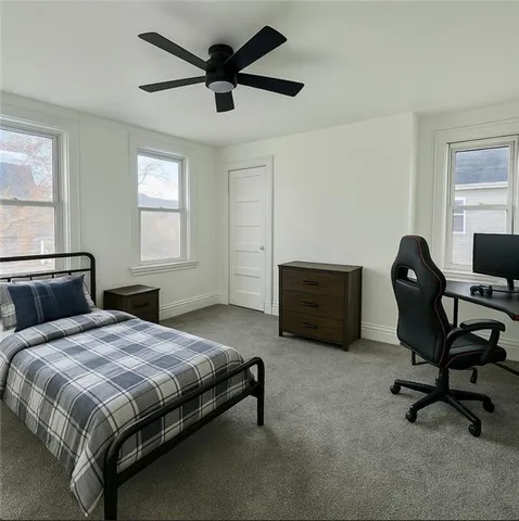 a bedroom with a bed a desk and chair