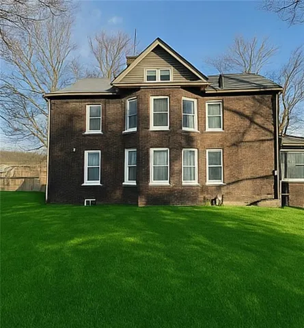 a view of house with yard