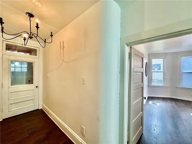 a view of a hallway with wooden floor and stairs