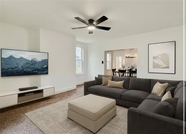 an empty room with a ceiling fan and windows