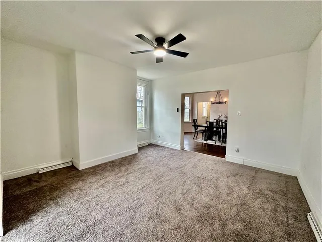 a view of a livingroom with a furniture chandelier fan and windows