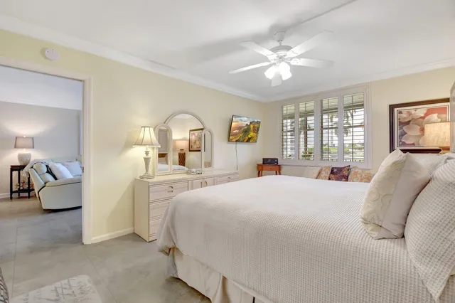 a bedroom with a bed and ceiling fan