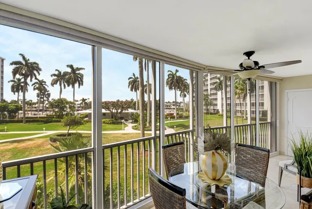 a view of a living room with a floor to ceiling window and wooden floor