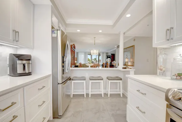 a kitchen with cabinets and chairs