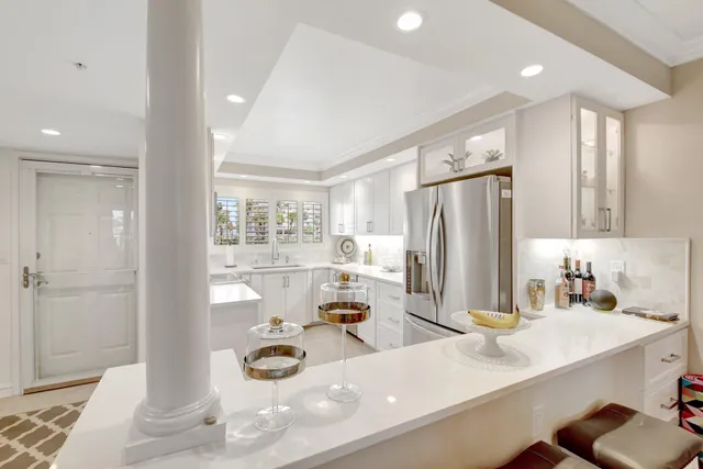 a kitchen with stainless steel appliances a sink and a refrigerator