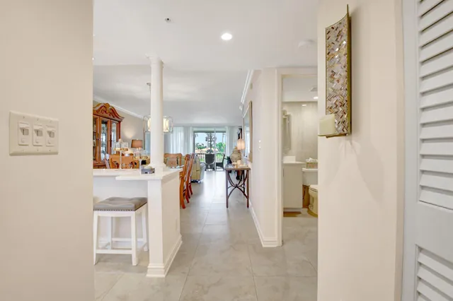 a view of a hallway with dining area closet and livingroom view