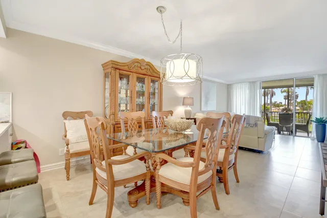 a dining room with furniture a chandelier and wooden floor