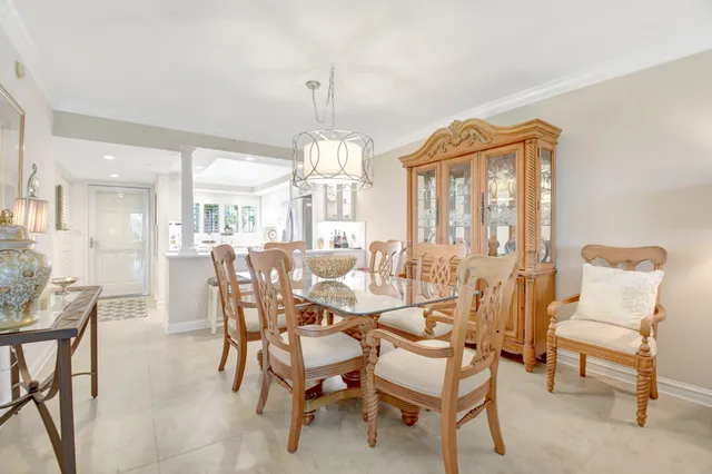 a view of a dining room with furniture and chandelier