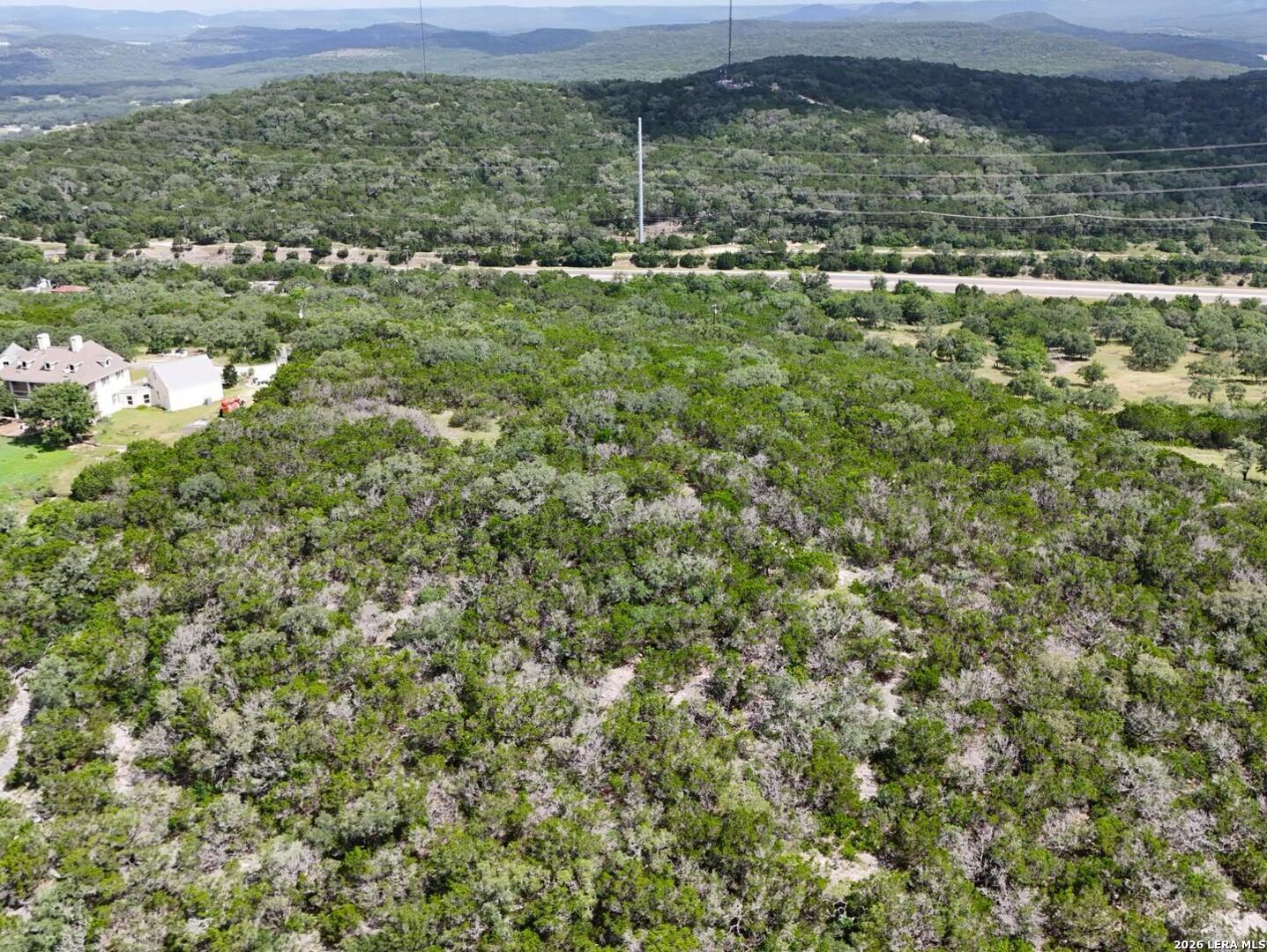 19031 Bandera Road Helotes, TX 78023 - Photo 20 of 37 a view of a green field with lots of bushes
