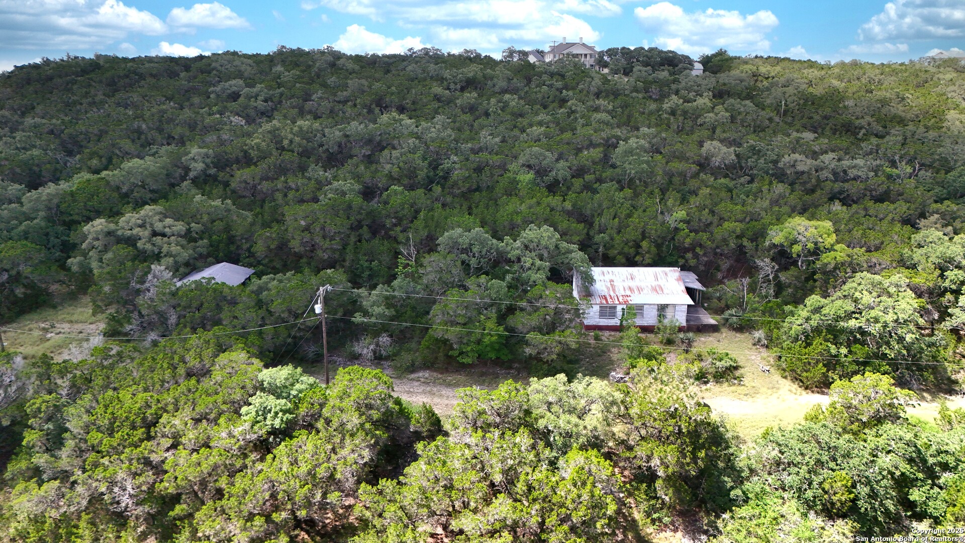19031 Bandera Road Helotes, TX 78023 - Photo 26 of 37 an aerial view of residential house with outdoor space and trees all around