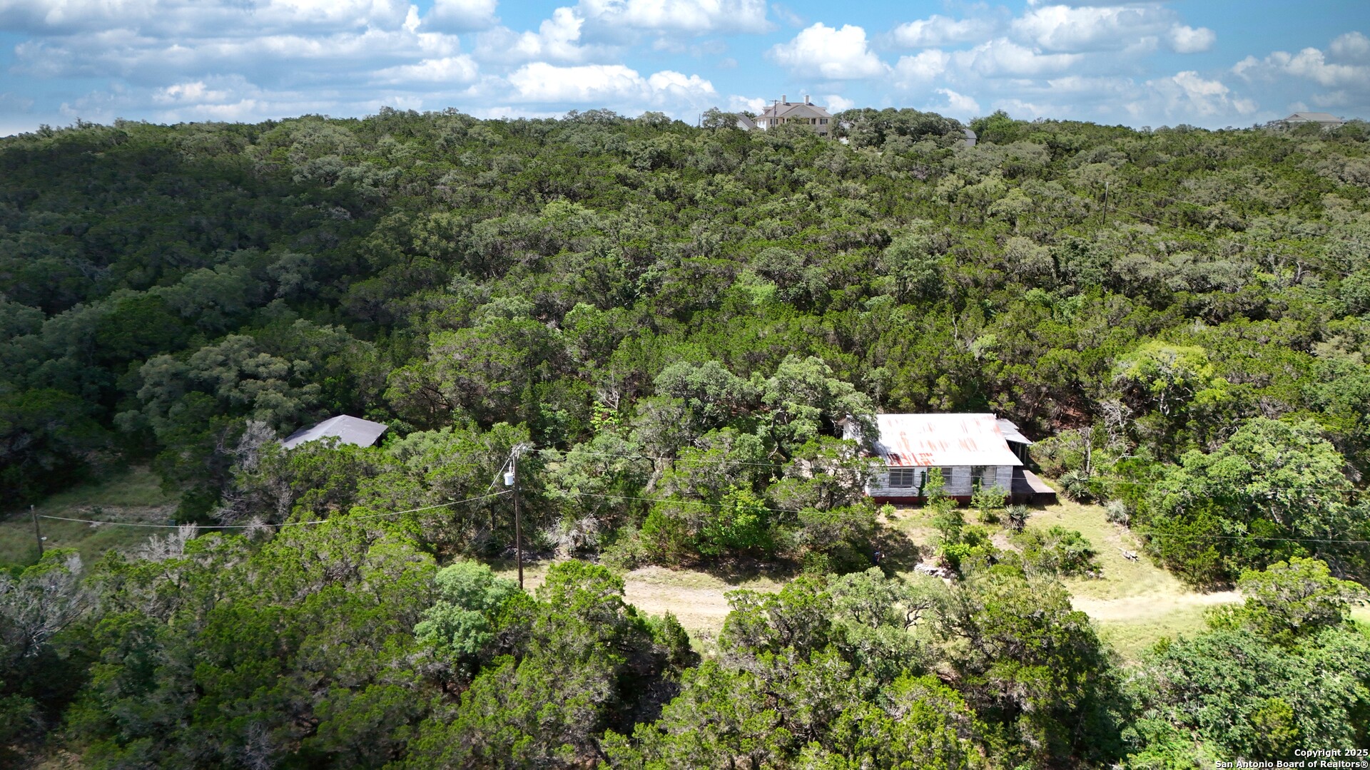 19031 Bandera Road Helotes, TX 78023 - Photo 27 of 37 a view of a house with a street and a garden