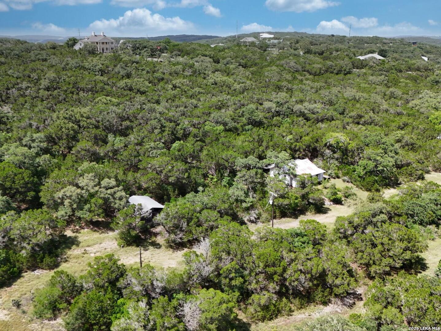 19031 Bandera Road Helotes, TX 78023 - Photo 29 of 37 a view of a houses with a lush green hillside