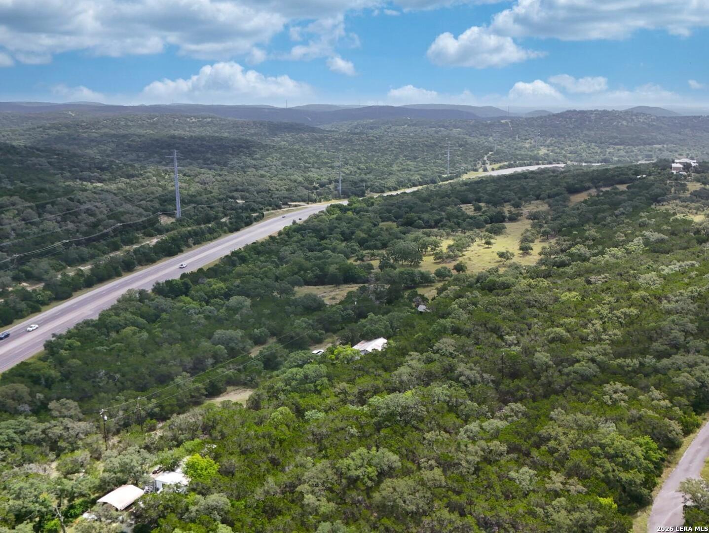 19031 Bandera Road Helotes, TX 78023 - Photo 3 of 37 a view of a city with lush green forest