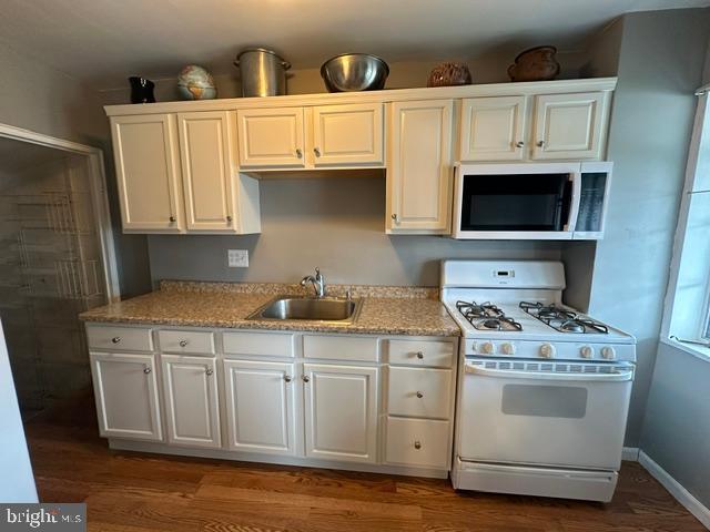1619 Inverness Avenue Baltimore, MD 21230 - Photo 10 of 30 a kitchen with white cabinets and white appliances