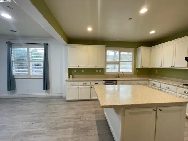 a kitchen with a sink cabinets and window