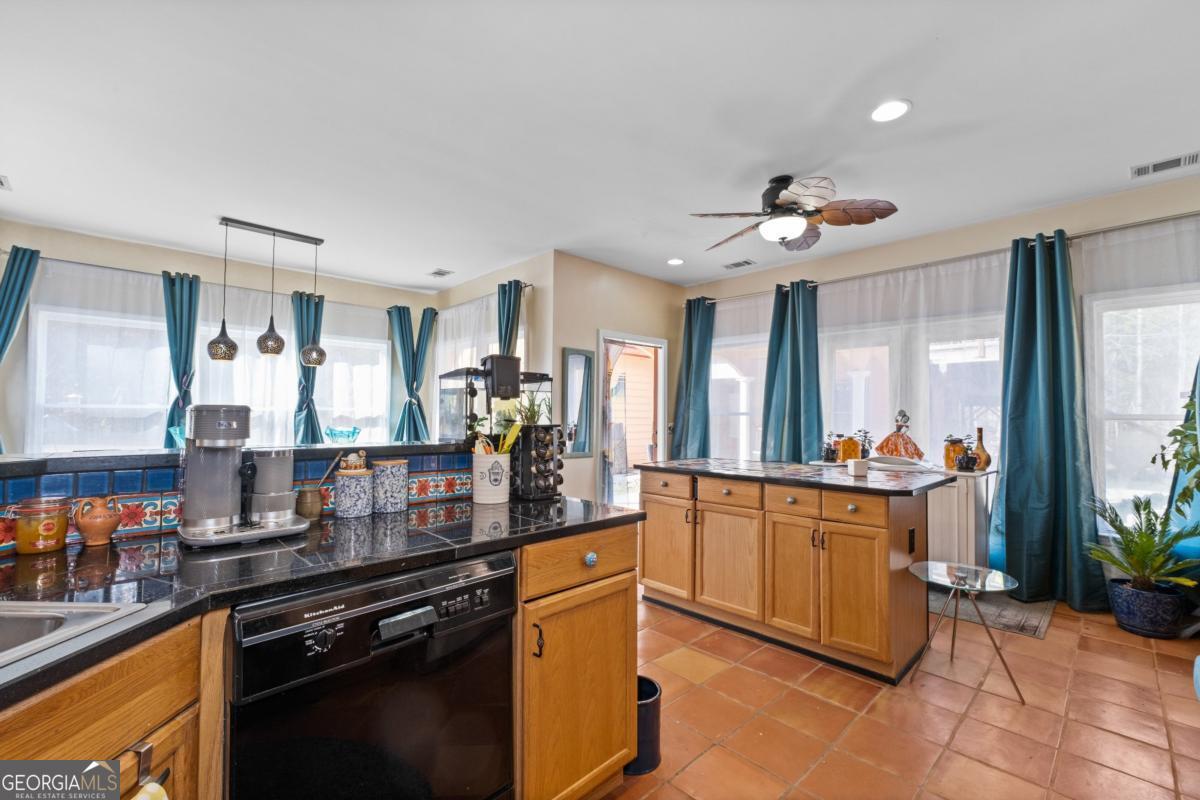 1045 Fincher Road Canton, GA 30114 - Photo 11 of 69 a kitchen with stainless steel appliances granite countertop a stove and a sink