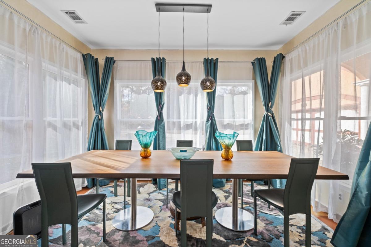 1045 Fincher Road Canton, GA 30114 - Photo 15 of 69 a view of a dining room with furniture large windows and wooden floor