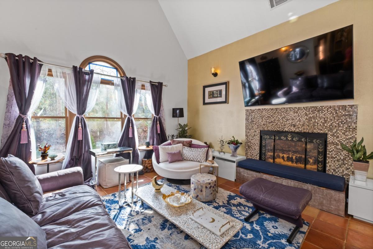 1045 Fincher Road Canton, GA 30114 - Photo 16 of 69 a living room with furniture a flat screen tv and a fireplace