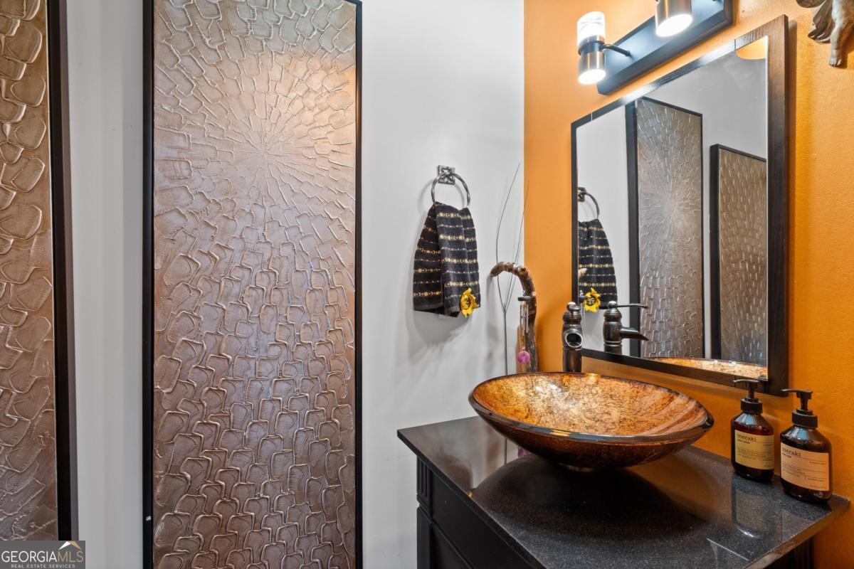 1045 Fincher Road Canton, GA 30114 - Photo 19 of 69 a view of a bathroom with a sink and a mirror