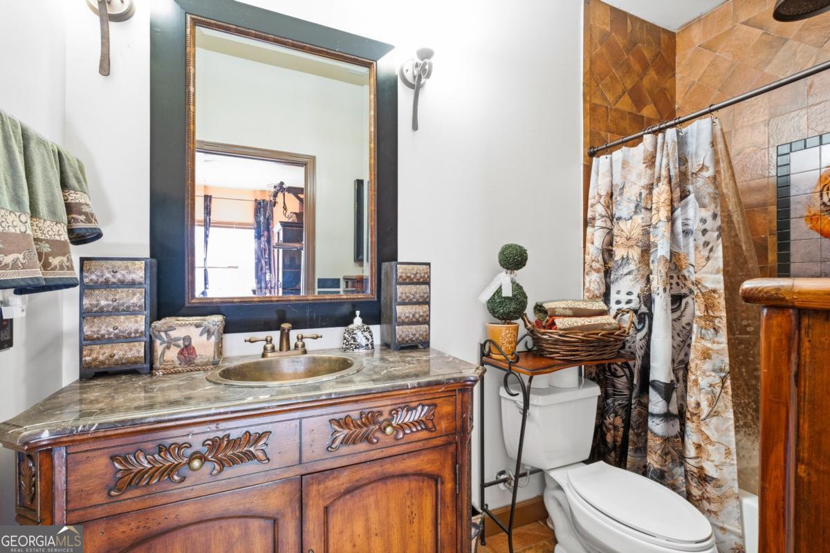1045 Fincher Road Canton, GA 30114 - Photo 23 of 69 a bathroom with a granite countertop toilet sink and mirror