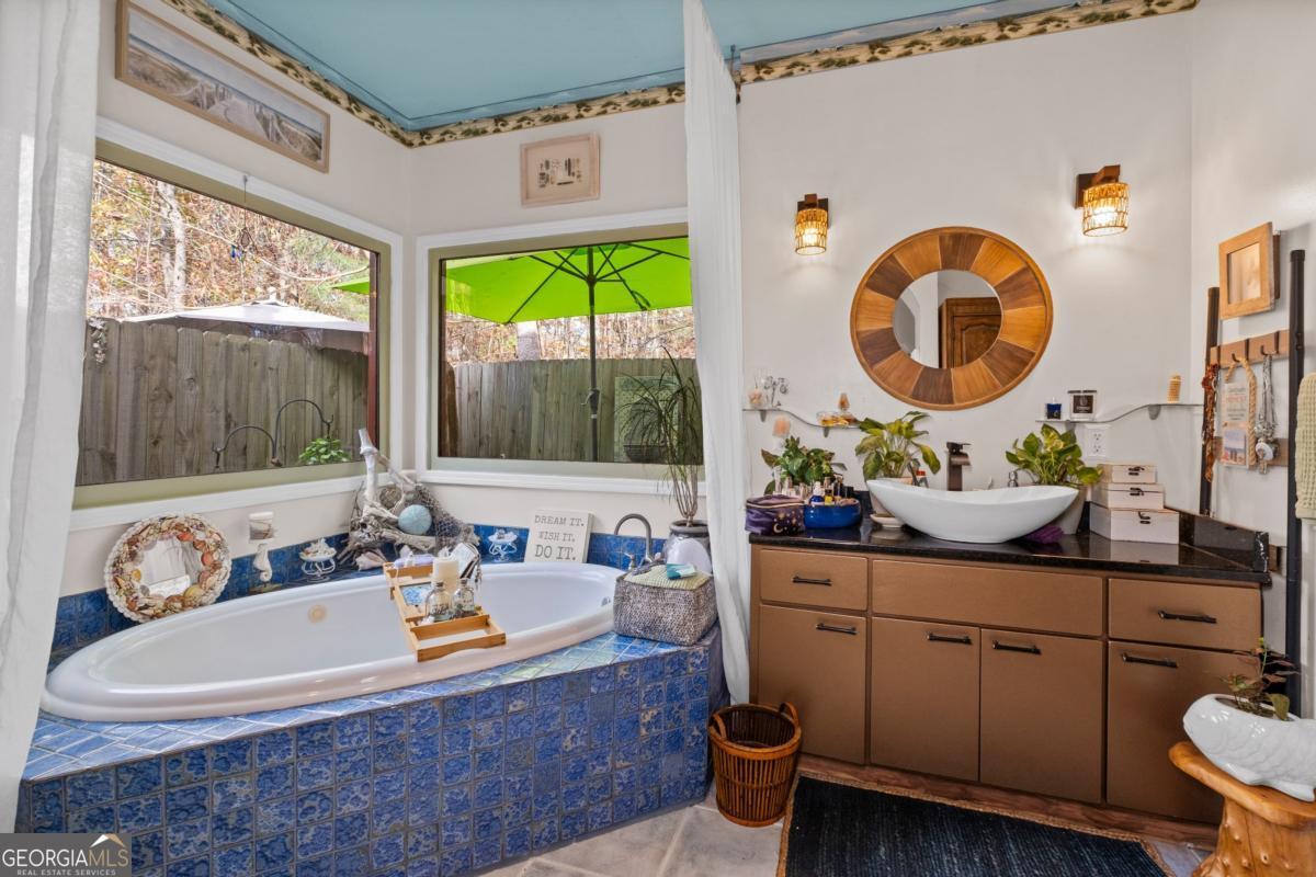 1045 Fincher Road Canton, GA 30114 - Photo 26 of 69 a bathroom with a sink a mirror and a large window