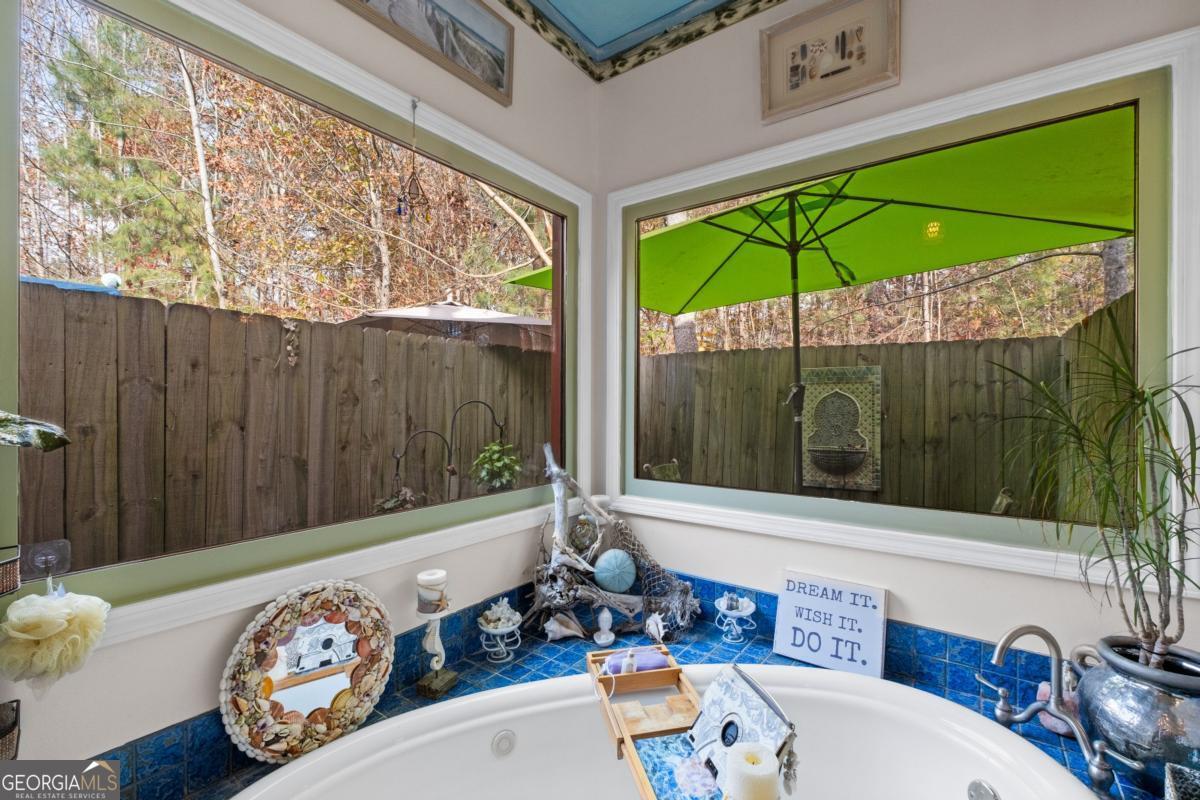 1045 Fincher Road Canton, GA 30114 - Photo 28 of 69 a view of a patio with table and chairs potted plants with wooden floor
