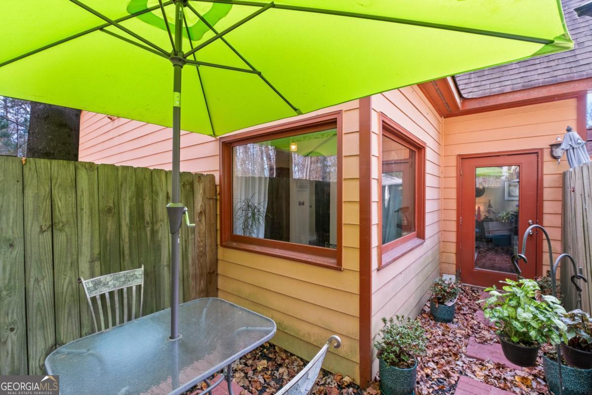 1045 Fincher Road Canton, GA 30114 - Photo 32 of 69 a view of a patio with table and chairs under an umbrella
