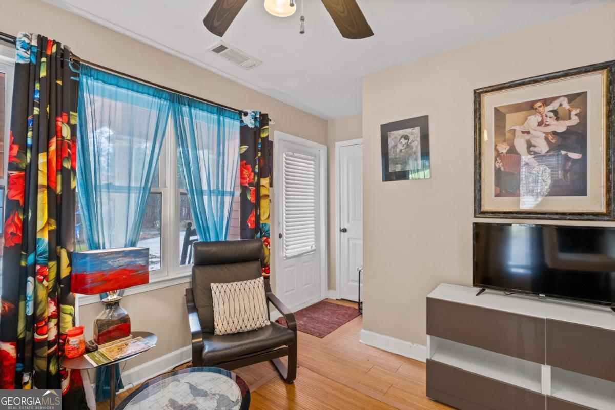 1045 Fincher Road Canton, GA 30114 - Photo 36 of 69 a living room with furniture and a flat screen tv