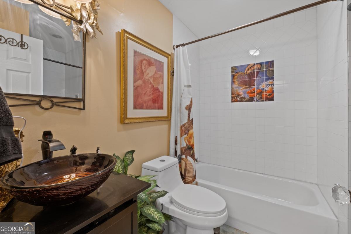 1045 Fincher Road Canton, GA 30114 - Photo 40 of 69 a bathroom with a toilet a sink and mirror