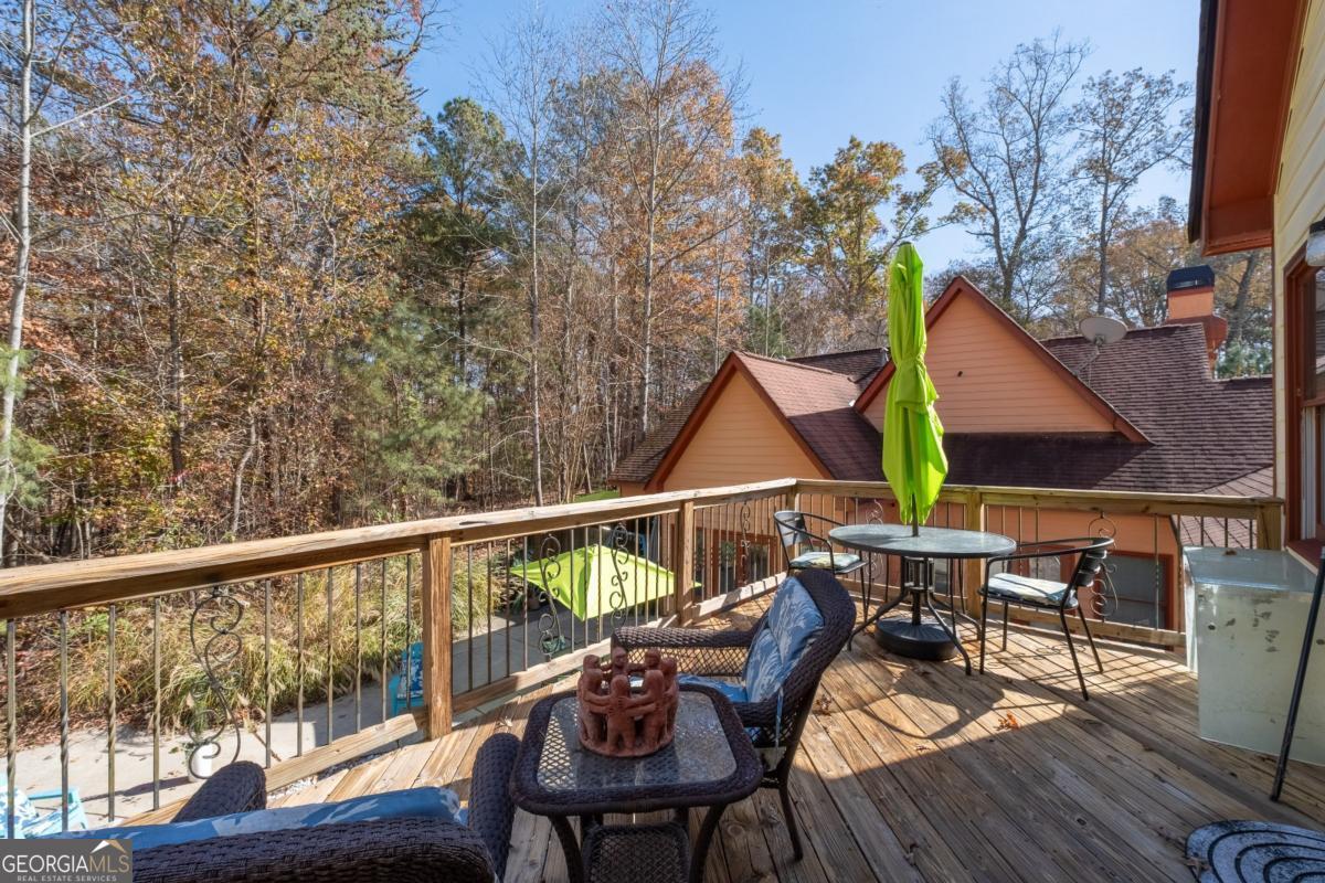 1045 Fincher Road Canton, GA 30114 - Photo 44 of 69 a view of deck with table and chairs a barbeque with wooden floor and fence