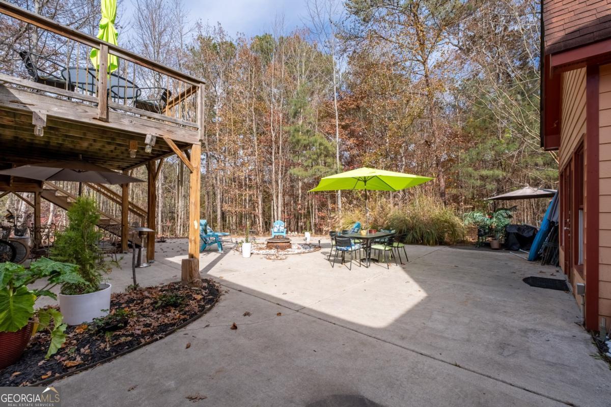1045 Fincher Road Canton, GA 30114 - Photo 55 of 69 a view of a backyard with a table and chairs under an umbrella