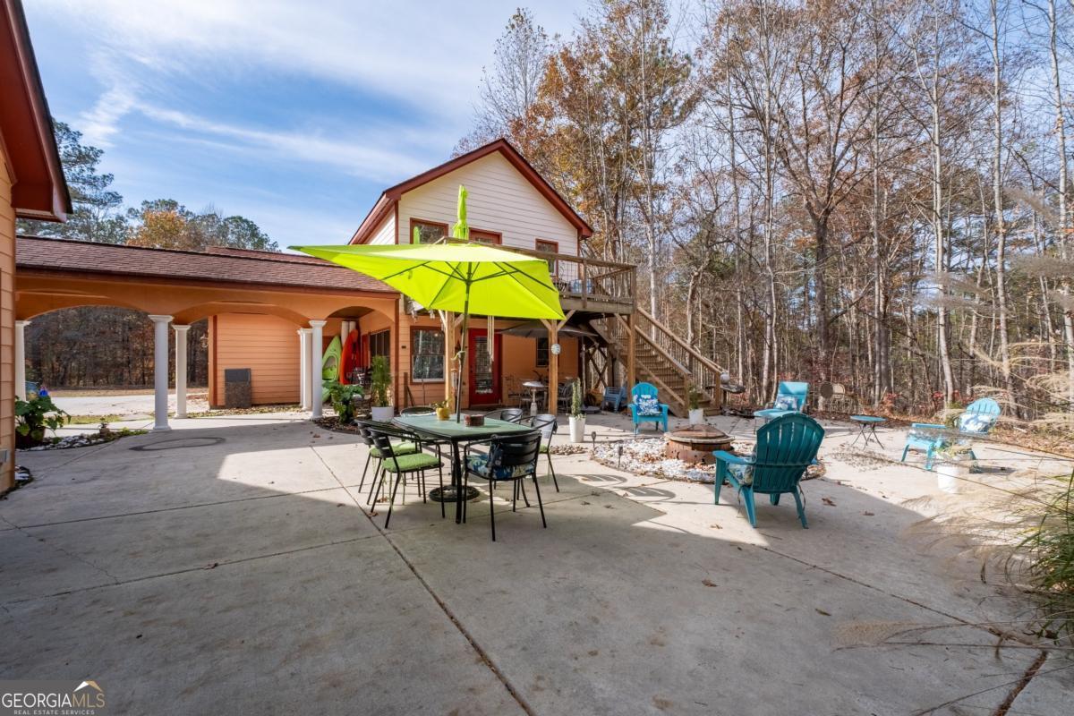 1045 Fincher Road Canton, GA 30114 - Photo 59 of 69 a view of a patio with a table and chairs under an umbrella