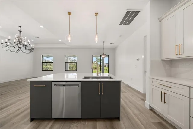 a kitchen with stainless steel appliances a refrigerator and a stove