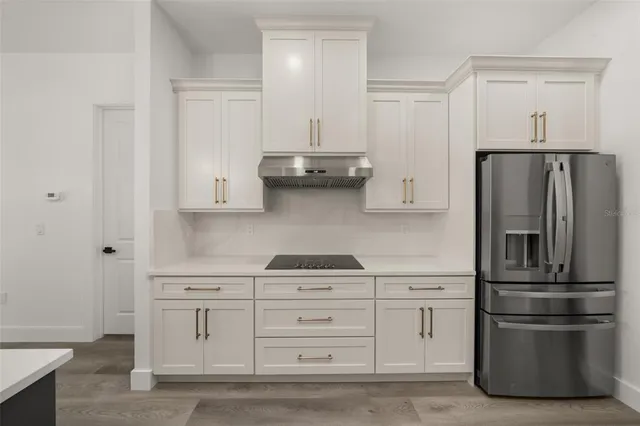 a view of a kitchen with a sink cabinets and a wooden floor