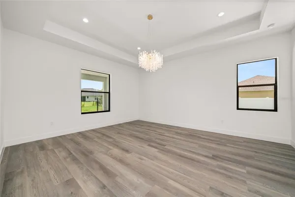 a large white bathroom with a sink a toilet and a mirror